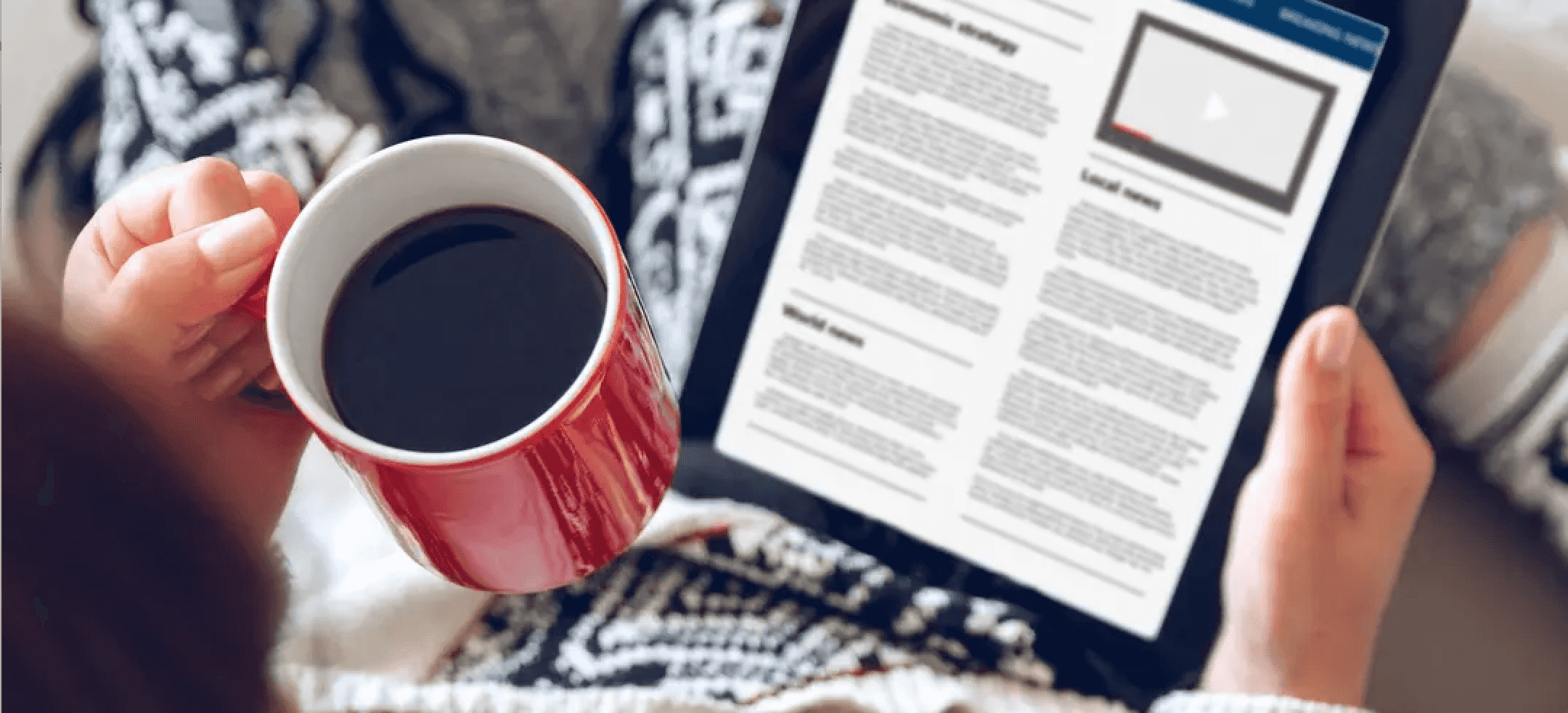 Women reading the news on her tablet with a cup of coffee