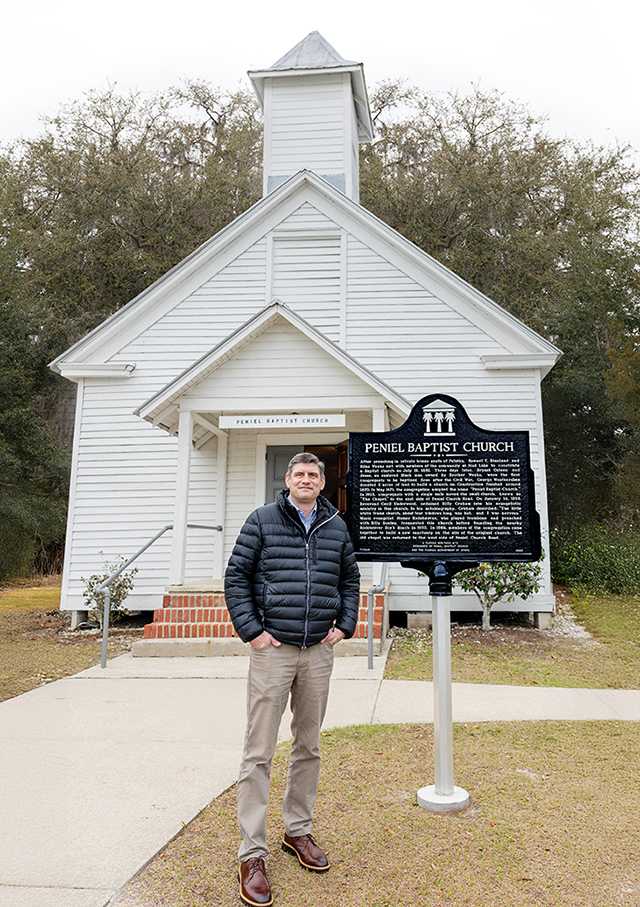 Will Graham stands in front of a church Will Graham stands in front of a church